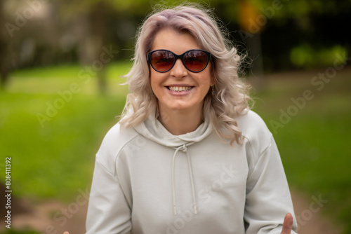 Stylish woman with silver hair in park
