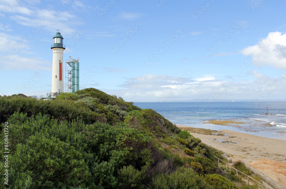 Lighthouse, beach, the ocean and grassy hill at Queenscliff in Victoria, Australia