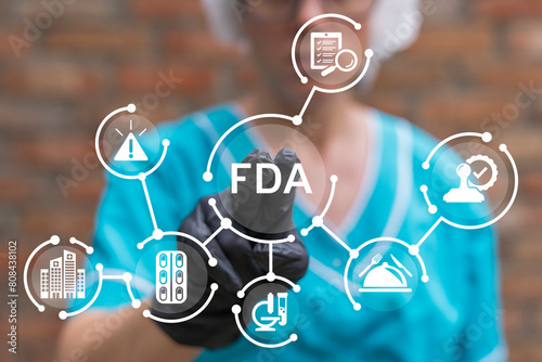 Doctor working on virtual touch screen presses abbreviation: FDA. Food and Drug Administration ( FDA ) Department Service Medical Concept. photo