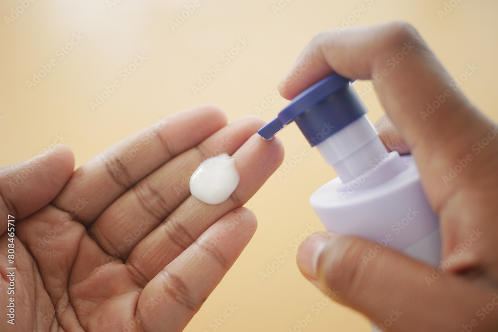 Close up of pouring moisturizing cream on hand Close up of pouring moisturizing cream on hand