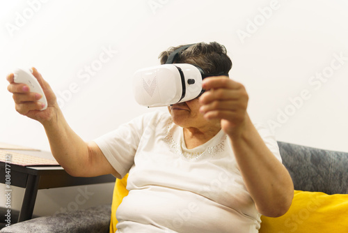 A woman is playing a video game with a remote control