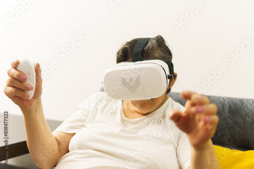 A woman wearing a white shirt and black strap is playing a video game