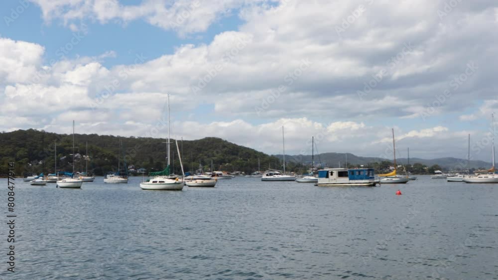 panning past boats in the harbor lake with beautiful view of mountains panning past boats in the harbor lake with beautiful view of mountains