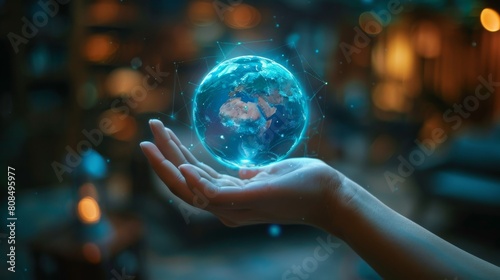 A hand holding a blue globe