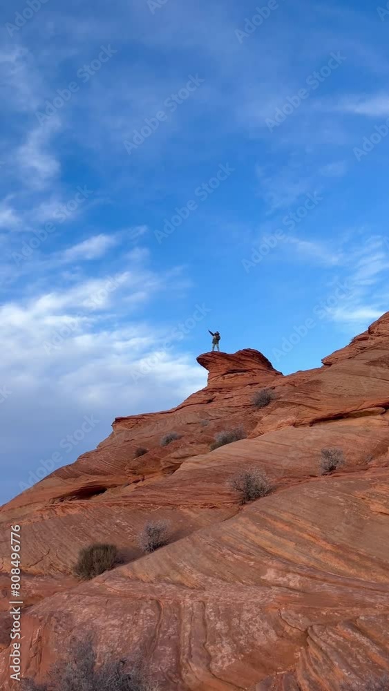 Young traveler male enjoying his solo own vacation time on top of Horseshoe Bend while looking the horizon checking on a map the landscape of Glen Grand Canyon National Park in Arizona, USA. Young traveler male enjoying his solo own vacation time on top of Horseshoe Bend while looking the horizon checking on a map the landscape of Glen Grand Canyon National Park in Arizona, USA.
