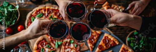 A group of friends toasting with red wine  surrounded by delicious pizza slices on the table  with a dark background  