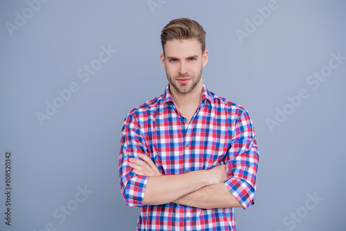 Skin care and men beauty concept. Caucasian millennial guy. Man in checkered shirt isolated on grey. Handsome man with hairstyle. Trendy male fashion. Male casual style. Portrait of handsome man