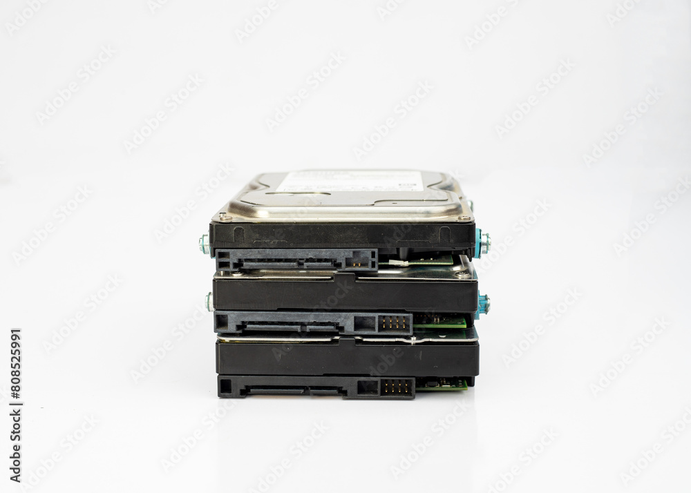 Stack of computer internal 3.5 inch hard disk drives on isolated white background Stack of computer internal 3.5 inch hard disk drives on isolated white background