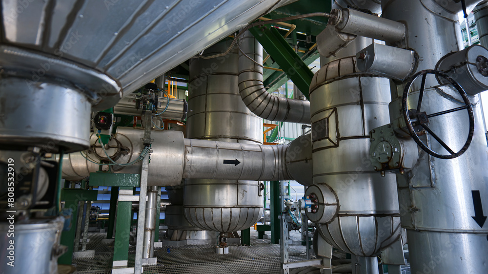 A large industrial plant with pipes and valves A large industrial plant with pipes and valves