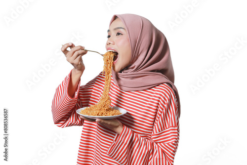 A portrait of a happy Asian woman hijab wearing a red white shirt, eating noodles. Isolated against a white background.