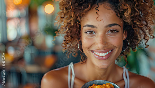 Close-up portrait of smiling woman with curly hair eating sweet potato crisps in a restaurant. Created with Ai photo