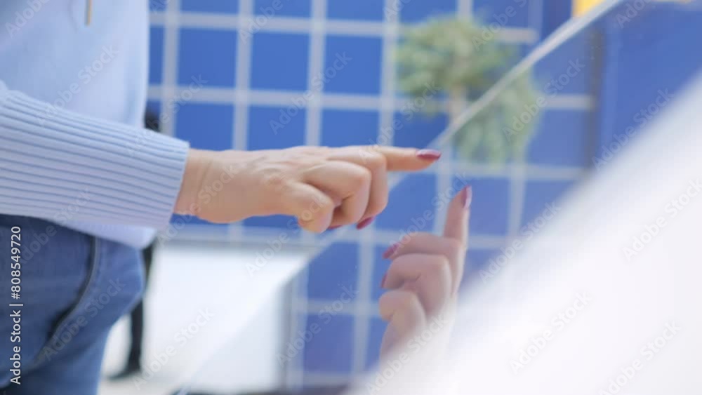 Entertainment and technology concept. Woman using interactive touchscreen display scrolling and touching. 4K Entertainment and technology concept. Woman using interactive touchscreen display scrolling and touching. 4K