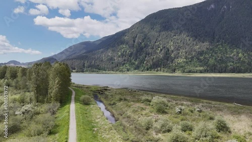 Aerial drone view (tilt up) of a cloudy day at the Pitt River Dike Scenic Point during a spring season in Pitt Meadows, British Columbia, Canada. photo