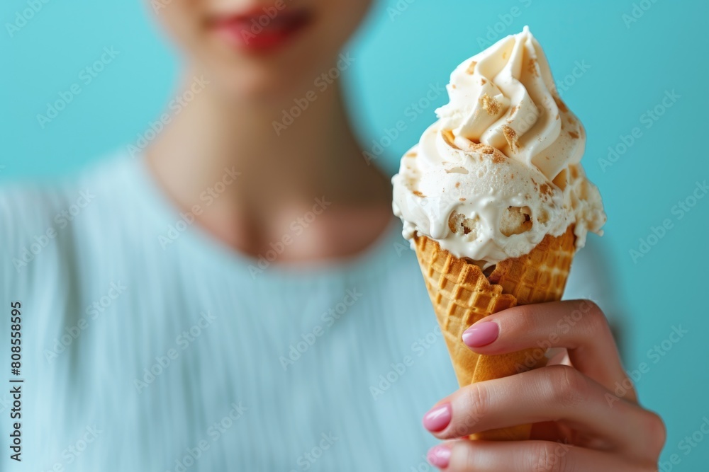 A woman holding a cone of ice cream