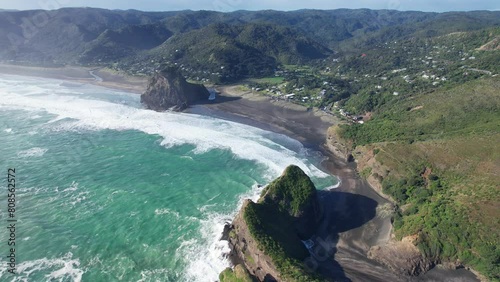 Crashing Waves On Piha Beach With Lion Rock And Taitomo Rock In Auckland Region, North Island, New Zealand. Aerial Shot photo