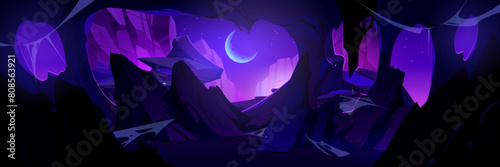 View from inside of cave on rocky cliff mountains at night with crescent moon on sky. Cartoon vector illustration of midnight landscape through underground grotto entrance hole. Empty stone cavern.