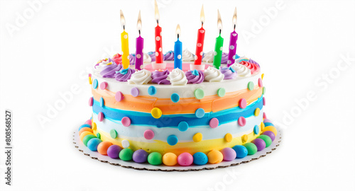 A colorful birthday cake with candles on it. The candles lit and the cake is decorated with colorful frosting on a white plate. colorful birthday cake with candles. isolated on white background