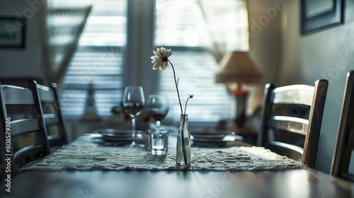 Dining table with a lace runner and a single flower in a vase, soft focus background of a dining room with a window and chairs, warm lighting photo