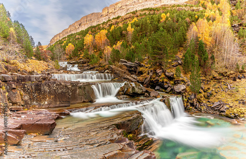 The magic of the autumn landscape of Monte Perdido, the Las Gradas de Soaso Waterfall is located in the Valley of the Arazas River, in the Ordesa y Monte Perdido National Park. photo