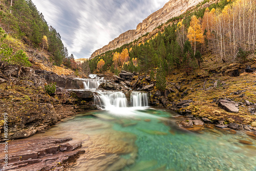 The magic of the autumn landscape of Monte Perdido, the Las Gradas de Soaso Waterfall is located in the Valley of the Arazas River, in the Ordesa y Monte Perdido National Park. photo