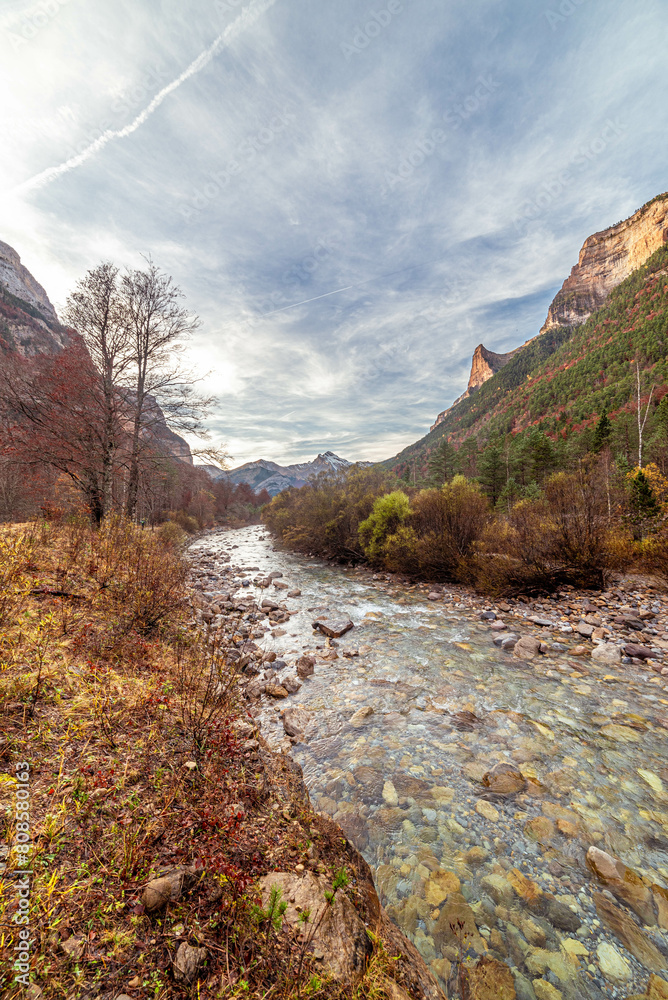 The magic of the autumn landscape of Monte Perdido in the Pyrenees, Arazas river in the background with the Cebollar peak, Torla, Huesca The magic of the autumn landscape of Monte Perdido in the Pyrenees, Arazas river in the background with the Cebollar peak, Torla, Huesca