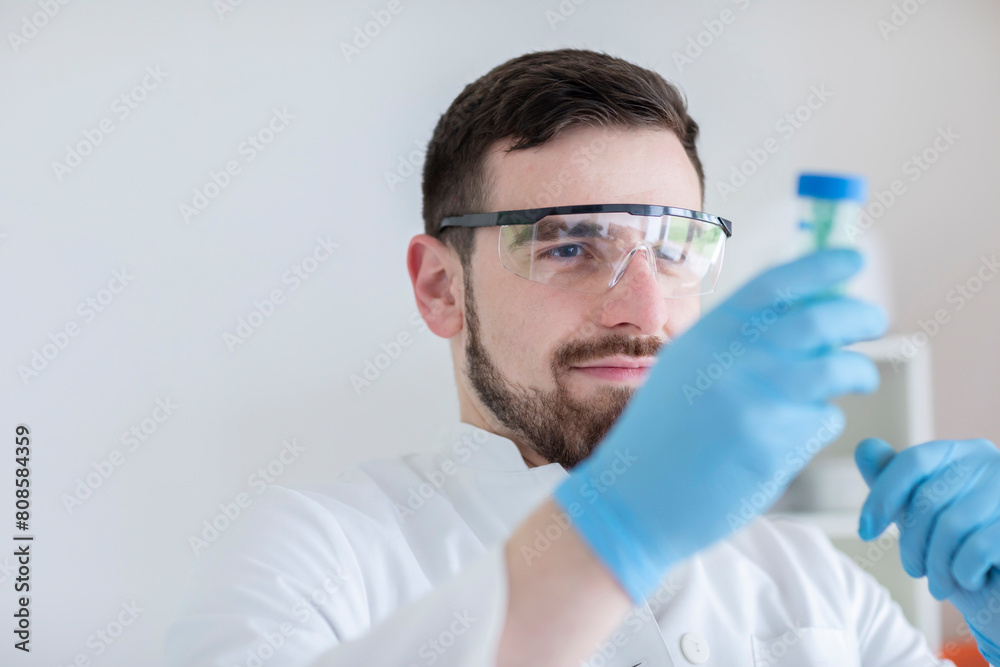 Scientist male with lab glasses working in a laboratory Scientist male with lab glasses working in a laboratory