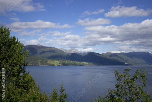 Scenic Lake View with Lush Mountains and Blue Skies in Norway