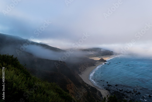 Misty coastal cliffs and ocean along the dramatic Big Sur coastline.