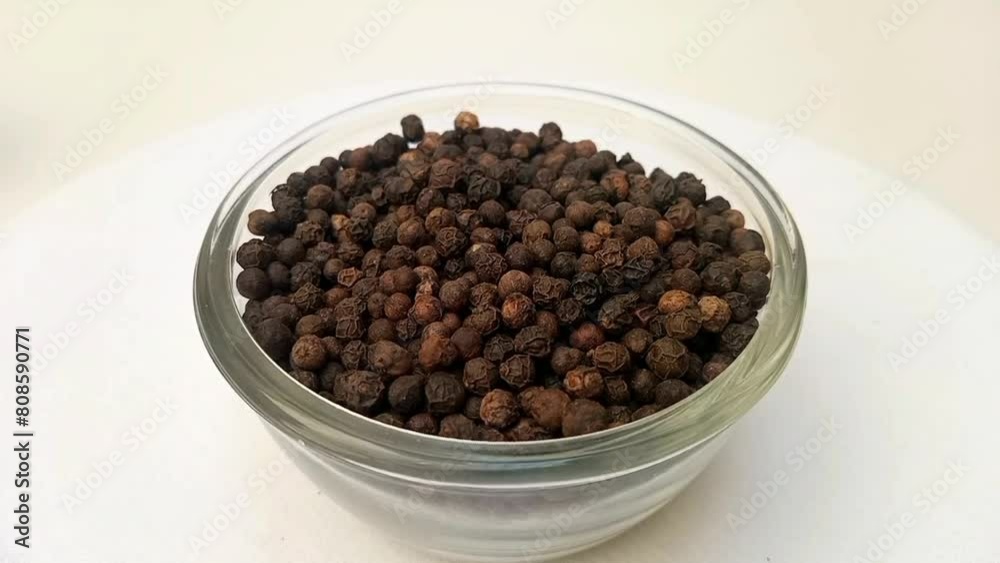 Black pepper in a glass bowl isolated rotating on white background, a glass bowl full of Black pepper in the center frame, zooming in, close up, herbs and spices Black pepper in a glass bowl isolated rotating on white background, a glass bowl full of Black pepper in the center frame, zooming in, close up, herbs and spices