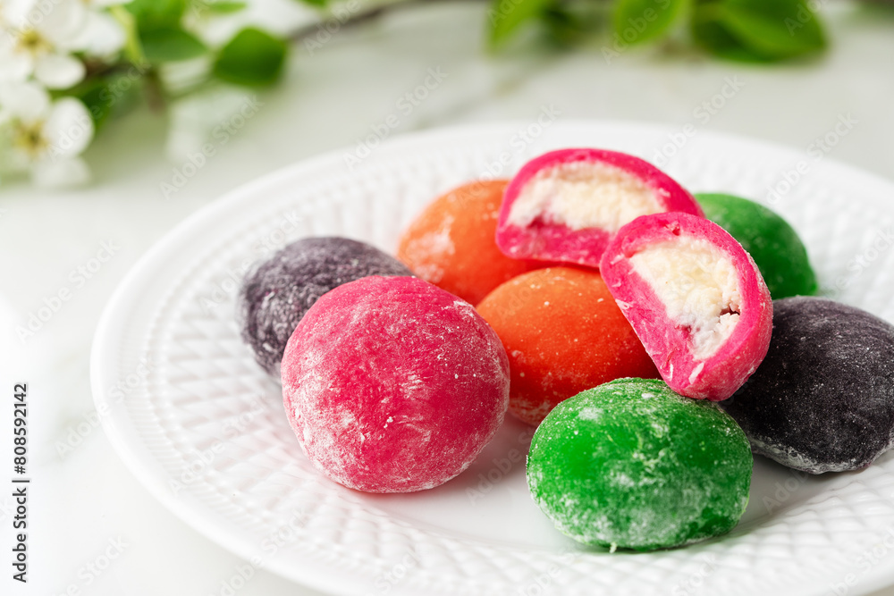 Multi-colored Japanese cakes Mochi in a white plate Multi-colored Japanese cakes Mochi in a white plate