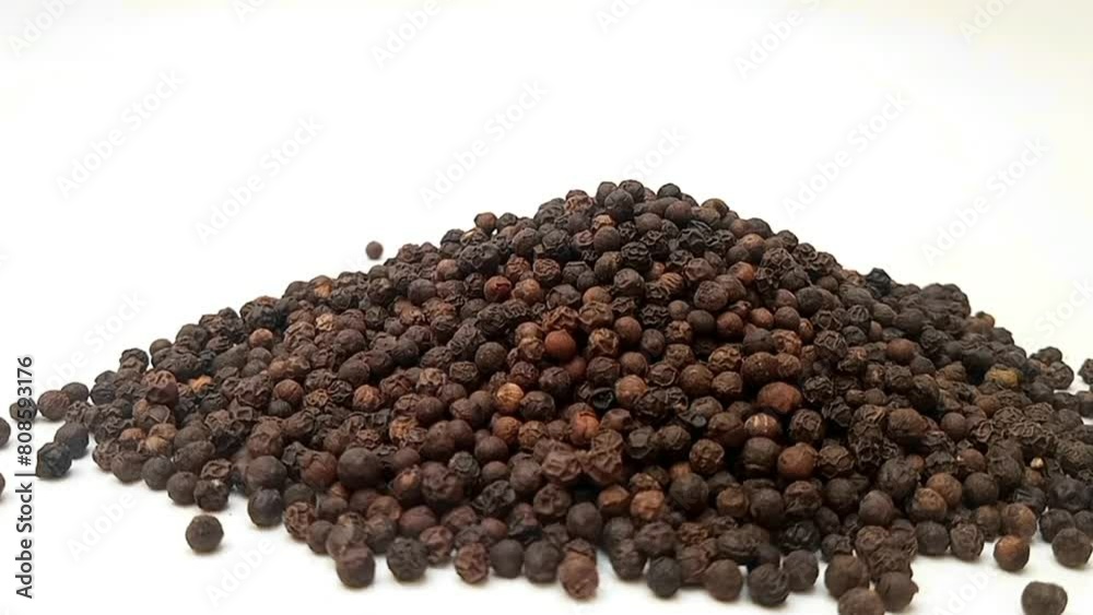 Pile of Black pepper on white background isolated, moving from right to left, front view, close up, herbs and spices Pile of Black pepper on white background isolated, moving from right to left, front view, close up, herbs and spices