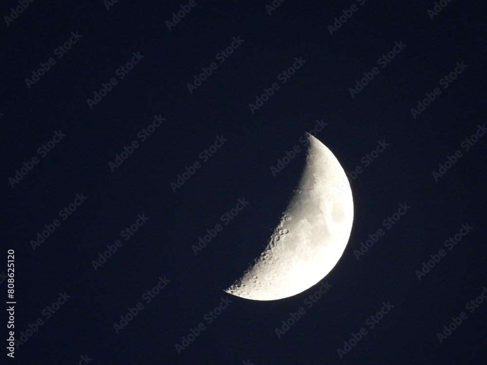 Close photo of the moon's surface taken at night Close photo of the moon's surface taken at night