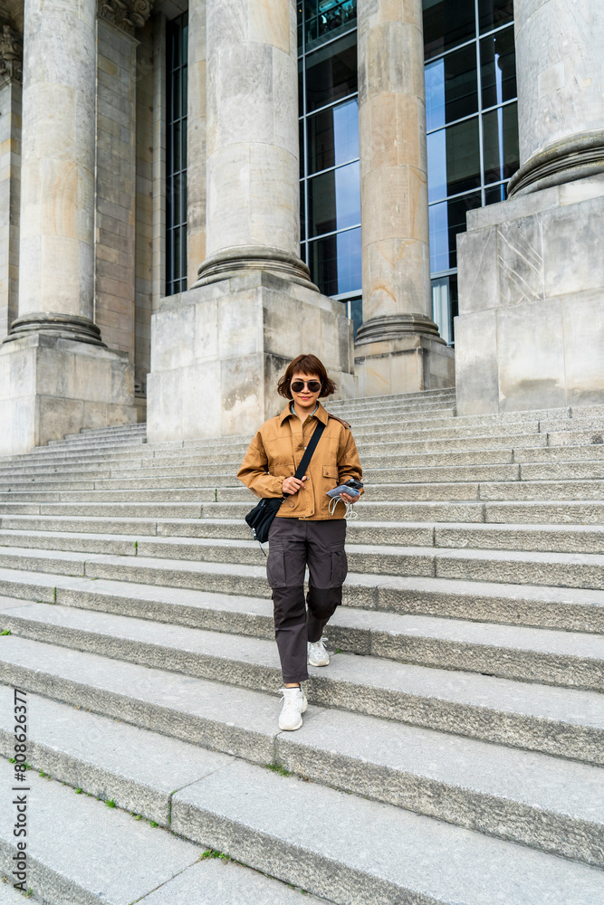 woman walking down the steps of the German parliament building woman walking down the steps of the German parliament building