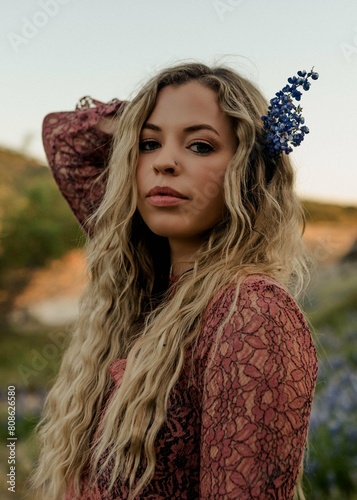 Blonde beauty with lupine flower, a portrait of allure photo
