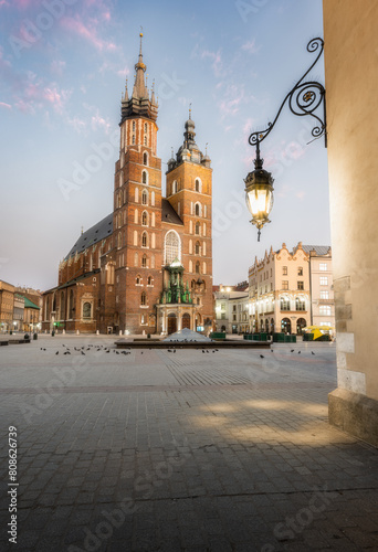 Asymmetrical Towers of St. Mary's Basilica at Sunset in Krakow's Rynek photo