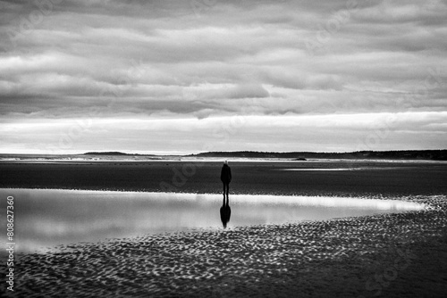 Person reflected in tide pool on cloudy day, Popham Beach, Maine photo