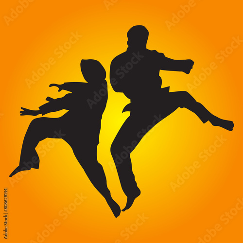 TWO ADULT PERFOMING MARTIAL ART SILAT SILHOUETTE photo