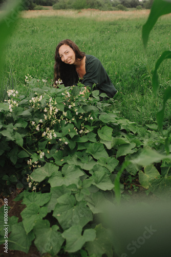 Female organic farmer rejoices over the harvest at her eco-farm. Concept green tourism, slow life, gardening, eco friendly. Part of the series