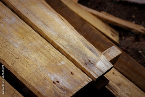 Close-up of wooden boards arranged neatly on the ground