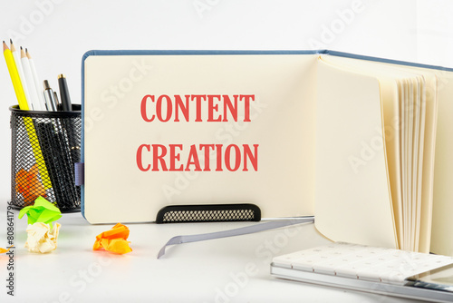 Business time for content creation concept. Concept words Content creation on a blank sheet of an open business notebook