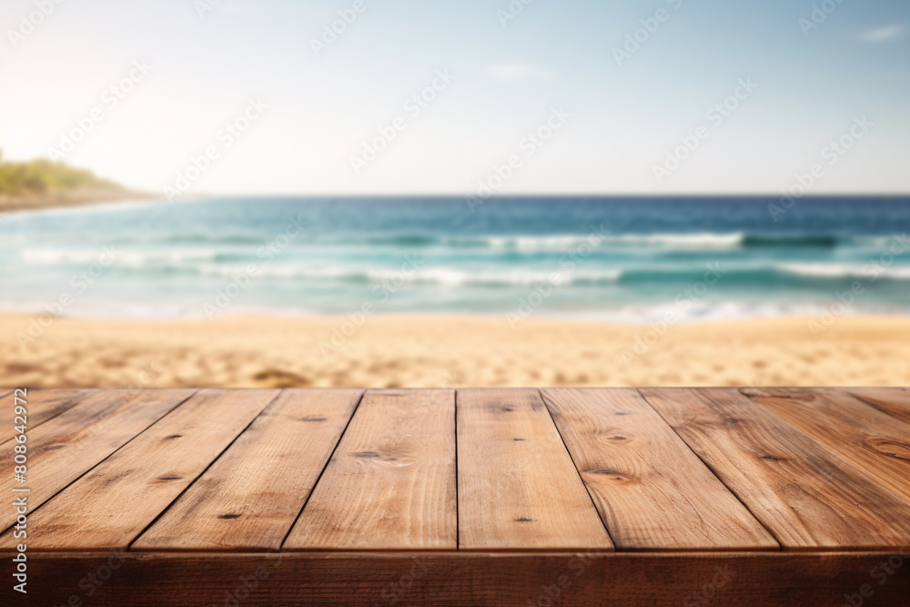 Empty wooden table with with blurry beach and ocean in background Empty wooden table with with blurry beach and ocean in background