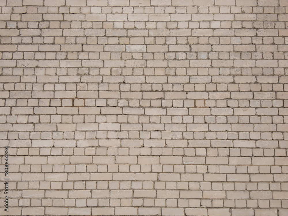 View of empty, white brick wall background with copy space. A deteriorating brick wall outdoors in sunlight View of empty, white brick wall background with copy space. A deteriorating brick wall outdoors in sunlight
