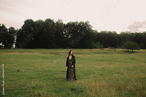 Calm woman enjoying the moment and slow life at her eco-farm. Concept green tourism, slow life, gardening, eco friendly. Part of the series