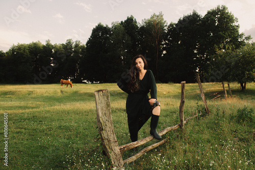 Calm woman enjoying the moment and slow life at her eco-farm. Concept green tourism, slow life, gardening, eco friendly. Part of the series