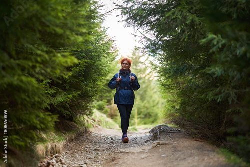 Hiker lady with backpack in the mountains