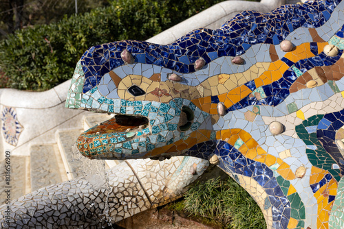 Multicolored mosaic of Salamander or Dragon. Lizard Fountain at Park Guell, popular touristic objects in Barcelona, Spain. Multicolored mosaic of Salamander or Dragon. Concept of tourism and vacation
