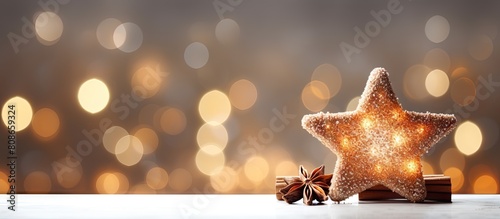 Horizontal holiday background with a star shaped copper cookie cutter The shiny white sparkling backdrop is adorned with bokeh lights creating a festive atmosphere for Christmas and New Year celebrat photo