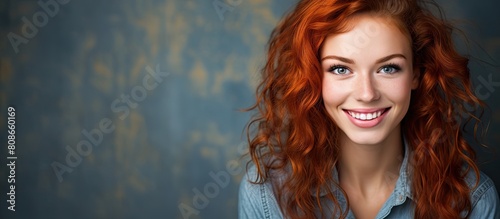 Charming redhead girl with a natural beauty happily smiling and looking at the camera allowing for copy space image photo