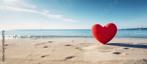 Beach backdrop with a vibrant red heart in the center providing ample copy space for text or images