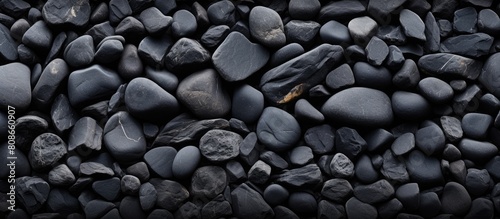 A smooth black stone surface serving as a background for design purposes allowing for copy space image placement